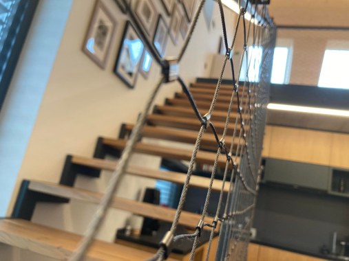 Wire mesh staircase railing in residential house