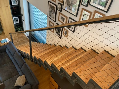 Wire mesh staircase railing in residential house
