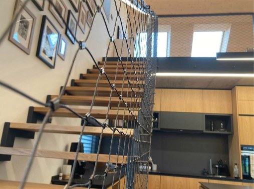 Wire mesh staircase railing in residential house