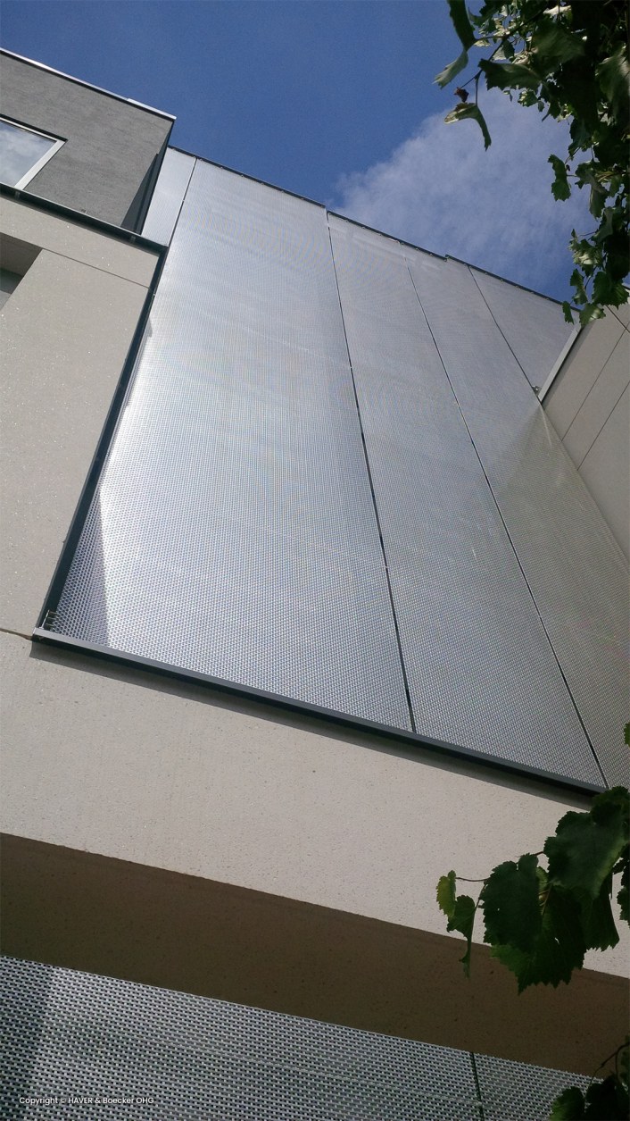 Building with a metal facade, wire fabrics used, creating an interesting network structure