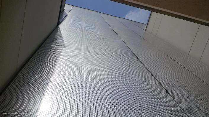 Building with metal facade, wire fabrics used, modern and minimalist facade effect