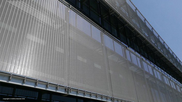 Functional shading and design element of the facade using wire mesh and fabrics